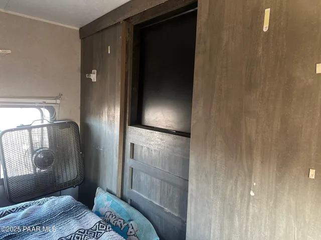a bedroom with a bed and a mirror
