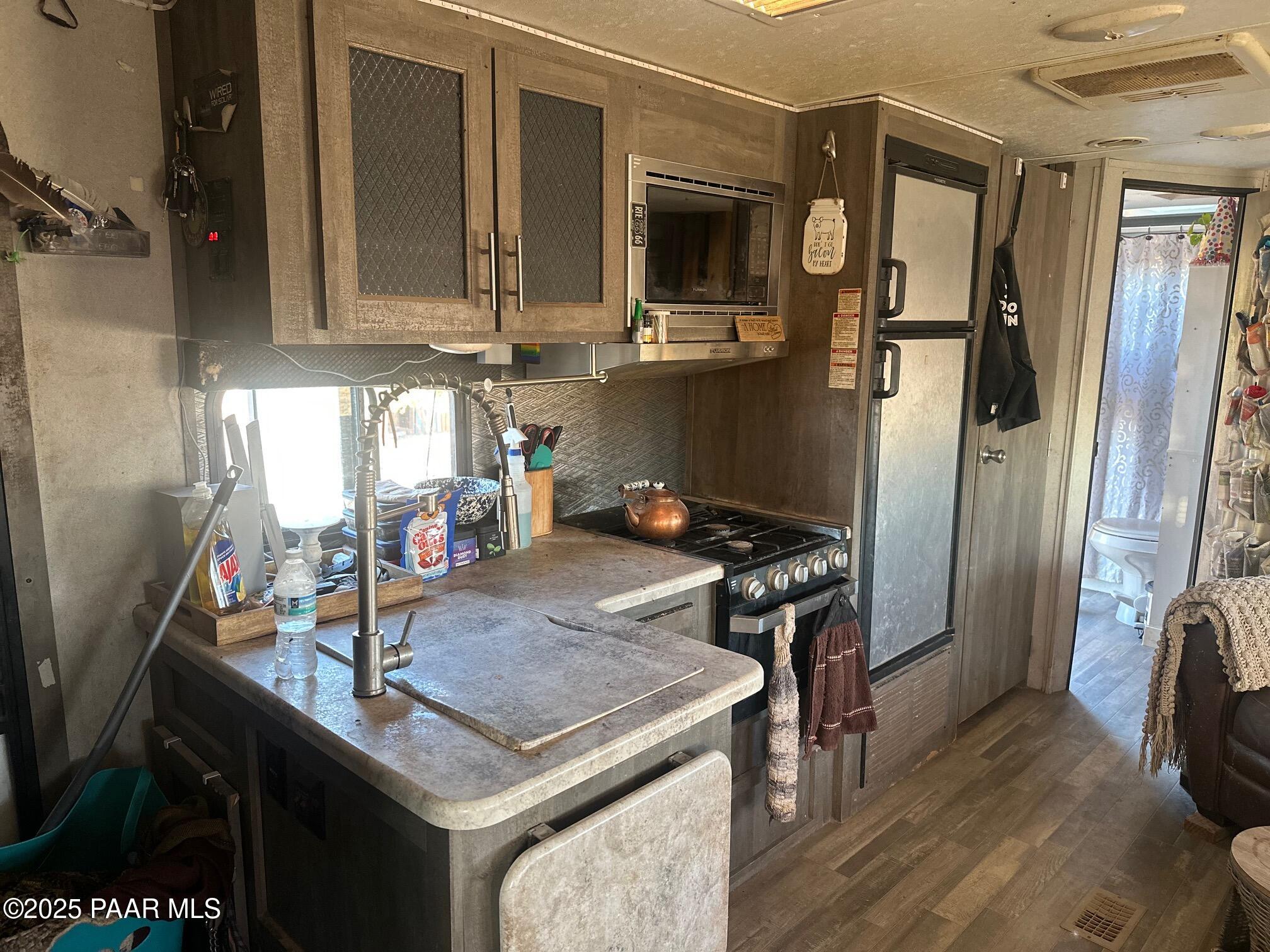 0 Triple H Ranch Road Ash Fork, AZ 86320 - Photo 8 of 46 a kitchen with stainless steel appliances granite countertop a sink stove and refrigerator