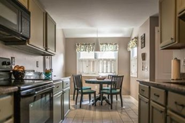 25 Highfield Road, Unit A Charlton, MA 01507 - Photo 8 of 30 a kitchen with stainless steel appliances a dining table chairs sink and cabinets
