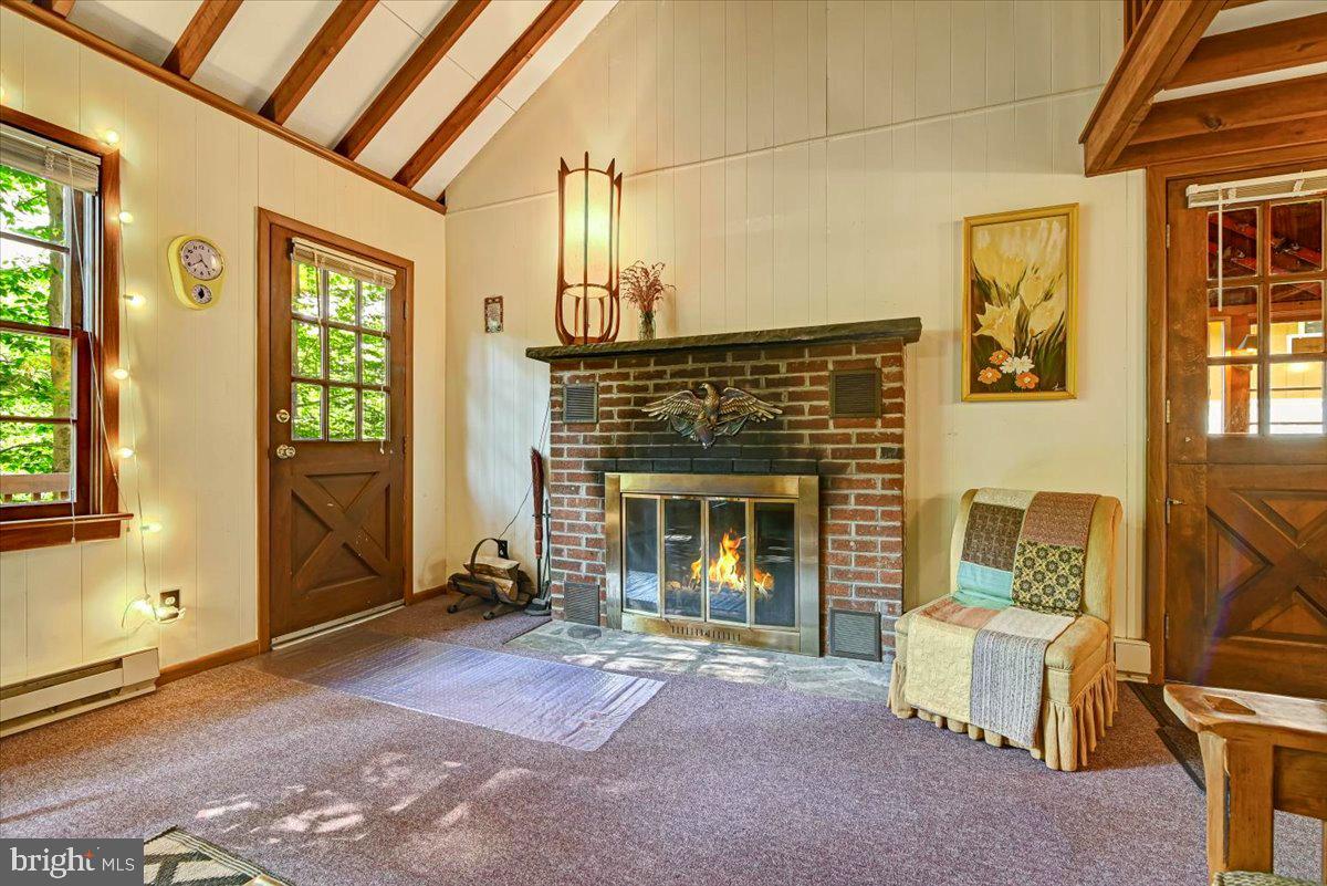 112 Beechwood Cove Road Greentown, PA 18426 - Photo 22 of 59 a living room with furniture and a fireplace
