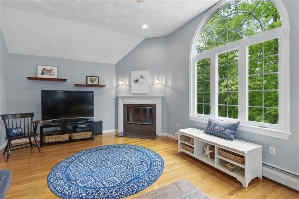 8 Valley Road Danvers, MA 01923 - Photo 15 of 41 a living room with furniture a flat screen tv and a fireplace