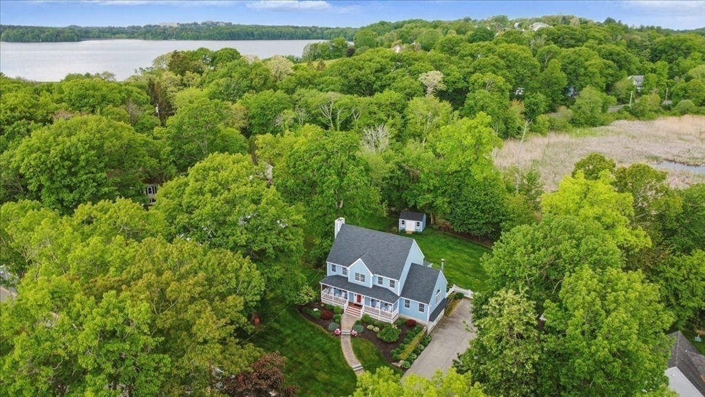 8 Valley Road Danvers, MA 01923 - Photo 2 of 41 a view of a garden with lawn chairs under an umbrella