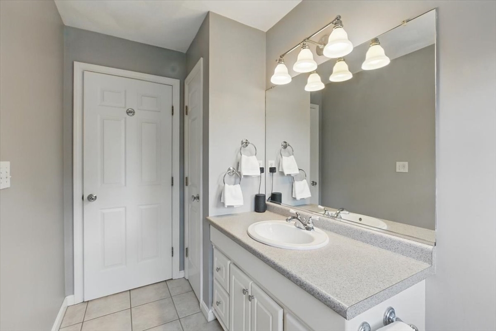 8 Valley Road Danvers, MA 01923 - Photo 33 of 41 a bathroom with a sink a light fixture and a mirror