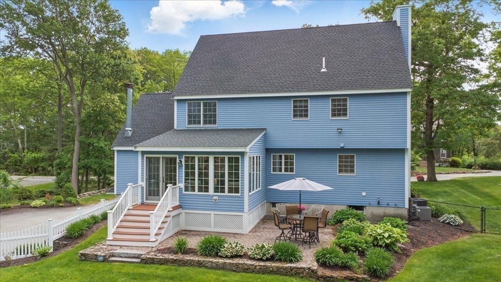 8 Valley Road Danvers, MA 01923 - Photo 4 of 41 a front view of a house with a yard table and chairs