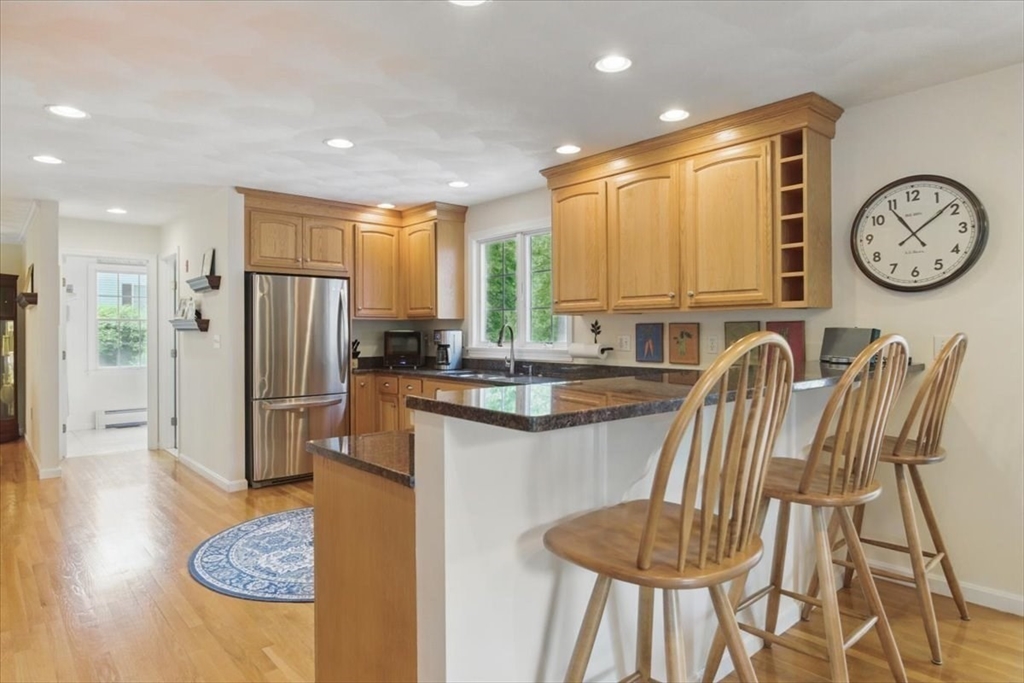 8 Valley Road Danvers, MA 01923 - Photo 10 of 41 a large kitchen with a table and a refrigerator