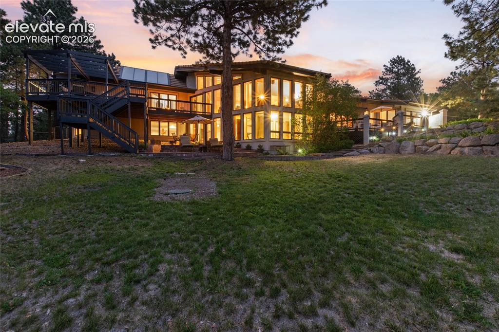 12730 Bridle Bit Road Colorado Springs, CO 80908 - Photo 42 of 50 Multi-level dwelling with extensive fenestration, multiple outdoor entertaining areas, and a lower-level patio