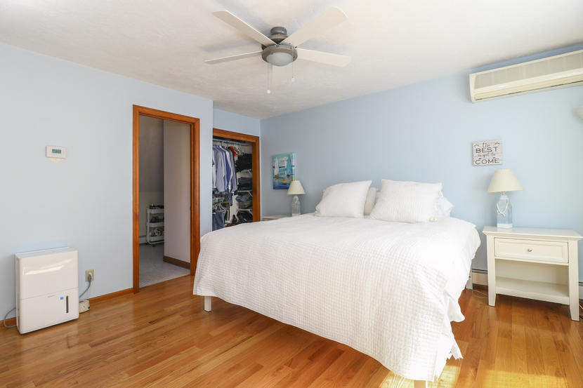 2 Samoset Road Mashpee, MA 02649 - Photo 16 of 41 a bedroom with a bed and a chandelier