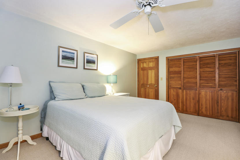 2 Samoset Road Mashpee, MA 02649 - Photo 21 of 41 a bedroom with a large bed and a chandelier