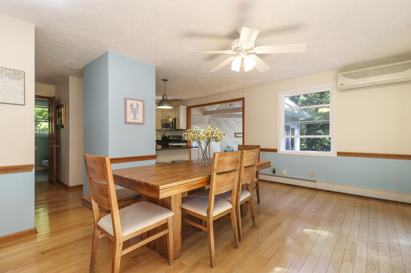 2 Samoset Road Mashpee, MA 02649 - Photo 8 of 41 a dining room with wooden floor a chandelier a glass table and chairs