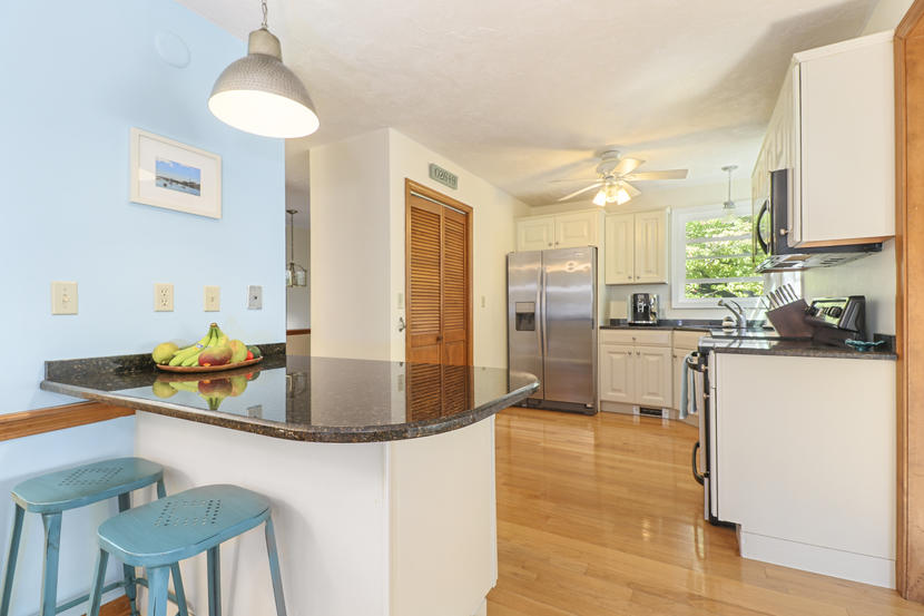 2 Samoset Road Mashpee, MA 02649 - Photo 9 of 41 a kitchen with stainless steel appliances granite countertop a sink a stove and a refrigerator