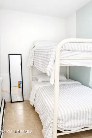 a bedroom with a bed and a mirror