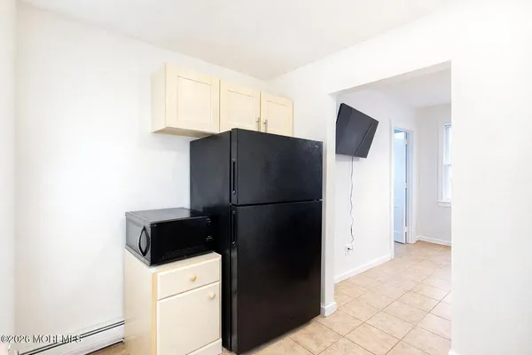 a kitchen with a refrigerator and cabinets