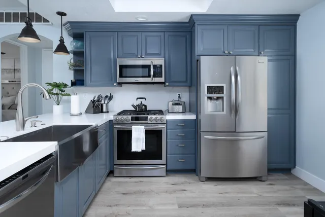 a kitchen with stainless steel appliances a refrigerator stove and microwave