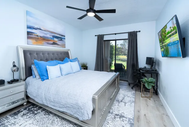 a bedroom with a bed and a dresser next to a window