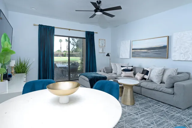 a living room with furniture and a potted plant