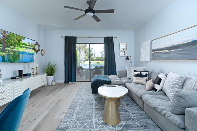 a living room with furniture a window and a chandelier