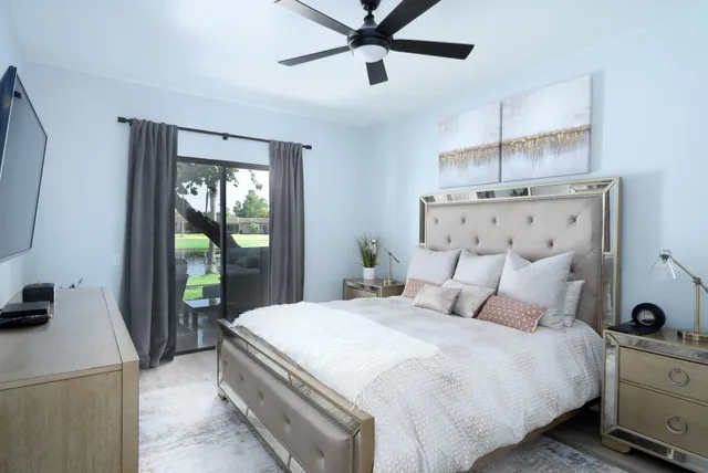 a bedroom with a balcony a bed and a chandelier