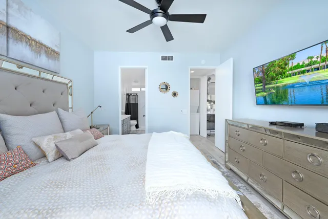 a bedroom with a bed and a chandelier