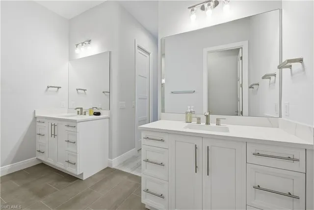 a bathroom with a double vanity sink and mirror