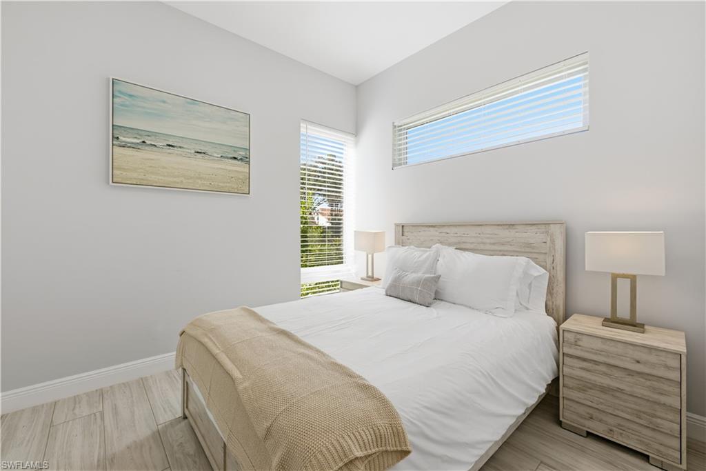 711 91st Avenue North Naples, FL 34108 - Photo 14 of 27 a bedroom with a bed and a lamp