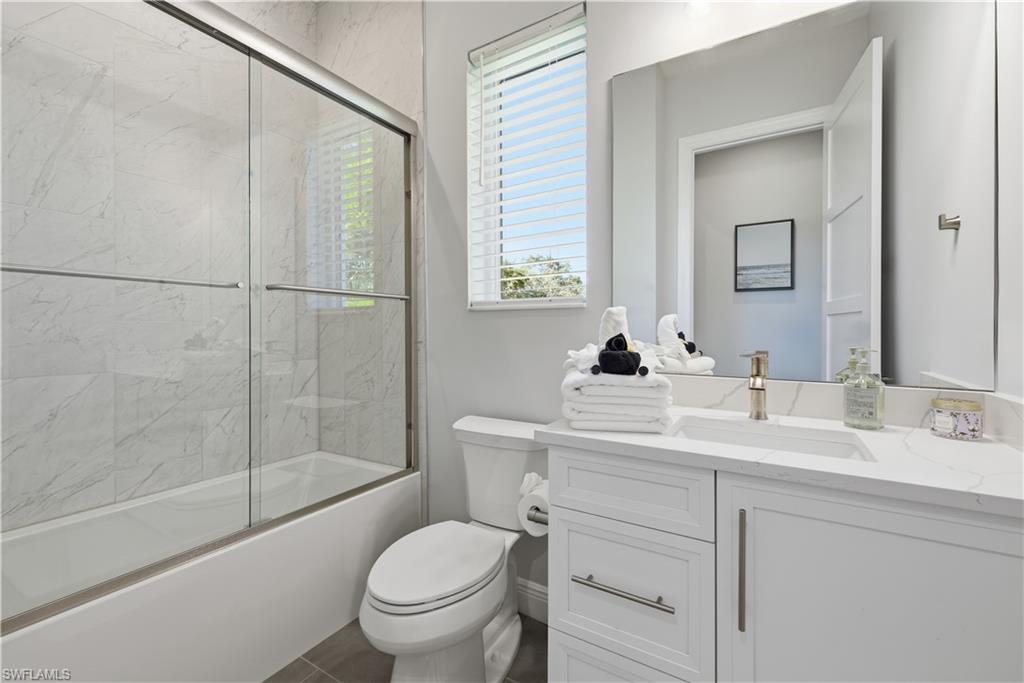 711 91st Avenue North Naples, FL 34108 - Photo 18 of 27 a bathroom with a sink toilet and shower
