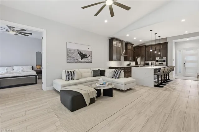 a living room with furniture and a wooden floor