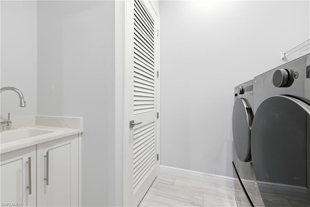 711 91st Avenue North Naples, FL 34108 - Photo 21 of 27 a bathroom with a sink and a mirror