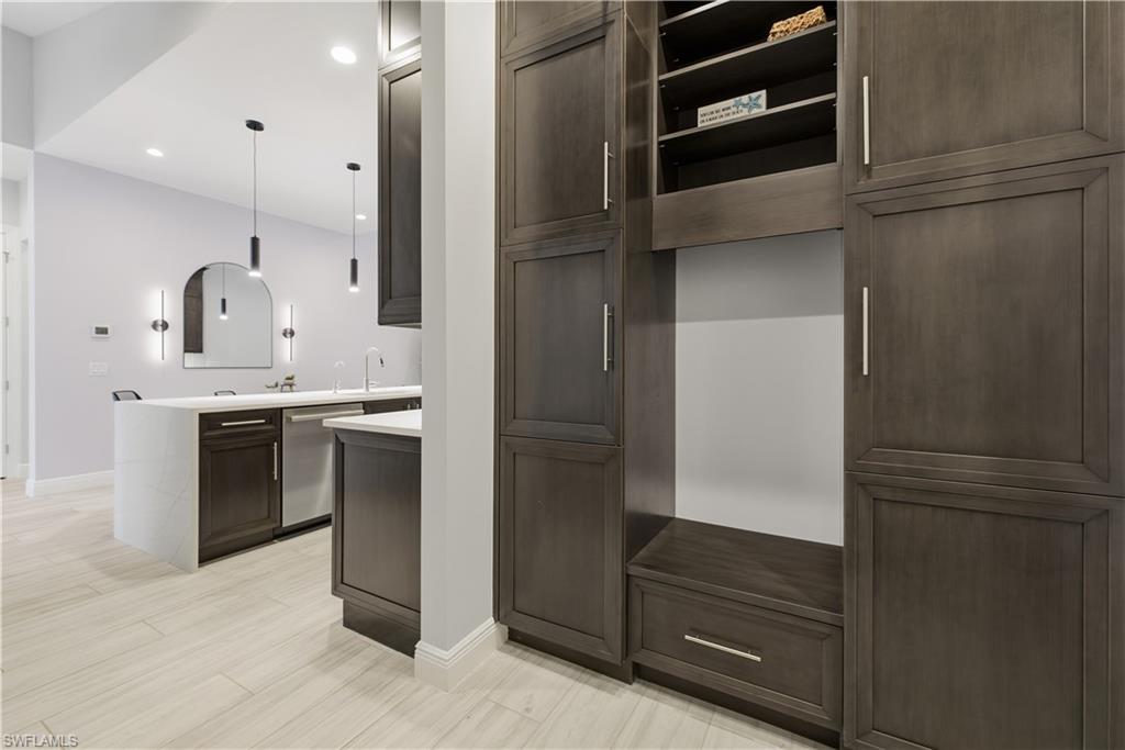 711 91st Avenue North Naples, FL 34108 - Photo 22 of 27 a kitchen with a refrigerator and a sink