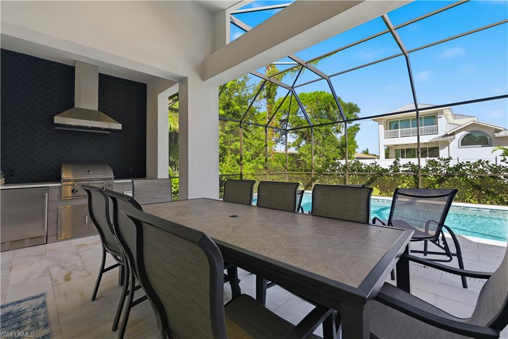 711 91st Avenue North Naples, FL 34108 - Photo 23 of 27 a view of a dining room with furniture window and outside view