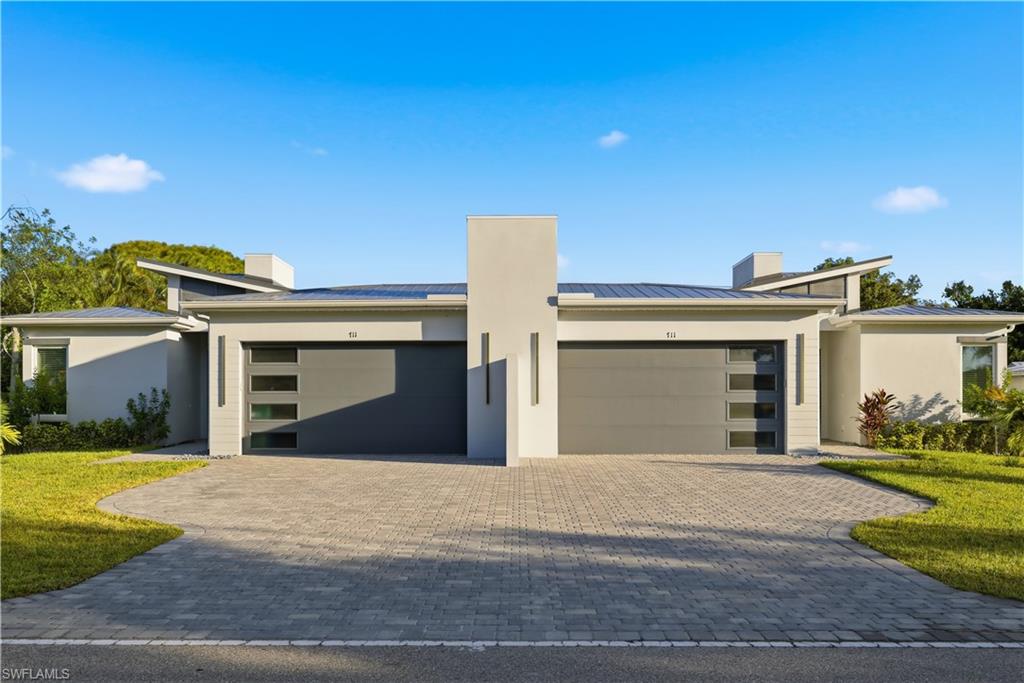 711 91st Avenue North Naples, FL 34108 - Photo 27 of 27 a view of a white house with a yard and plants