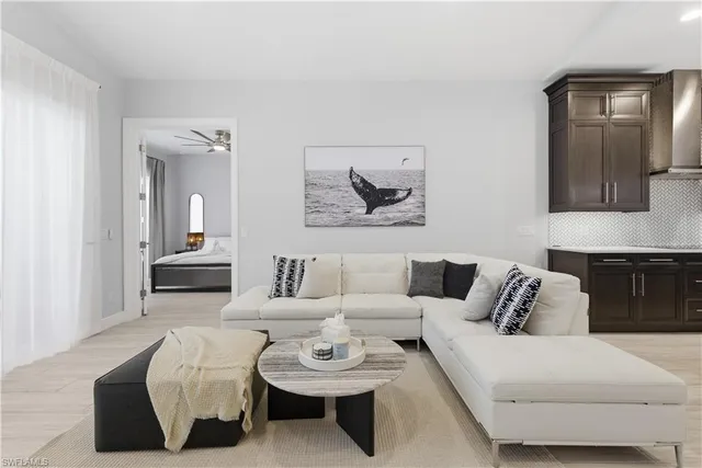 a living room with furniture and a mirror