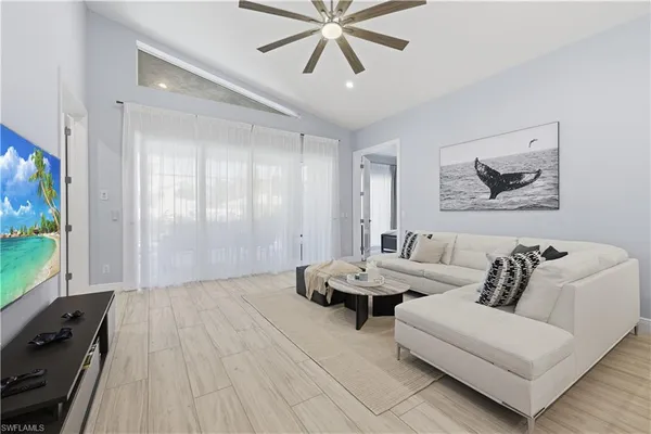 a living room with furniture and a flat screen tv