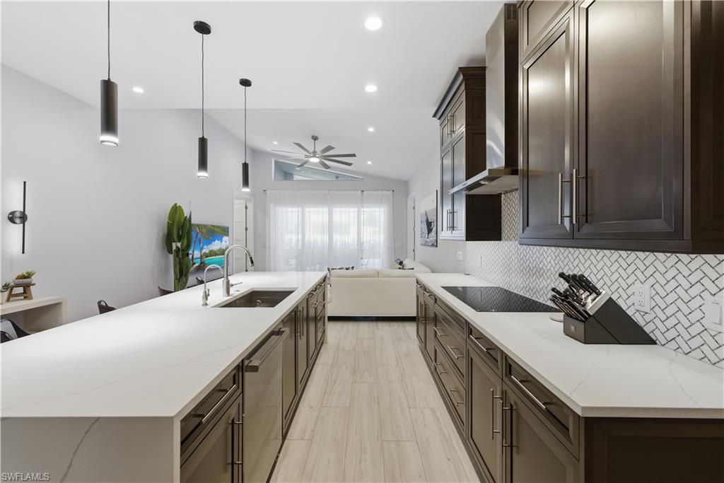 711 91st Avenue North Naples, FL 34108 - Photo 5 of 27 a kitchen with a sink stove and cabinets