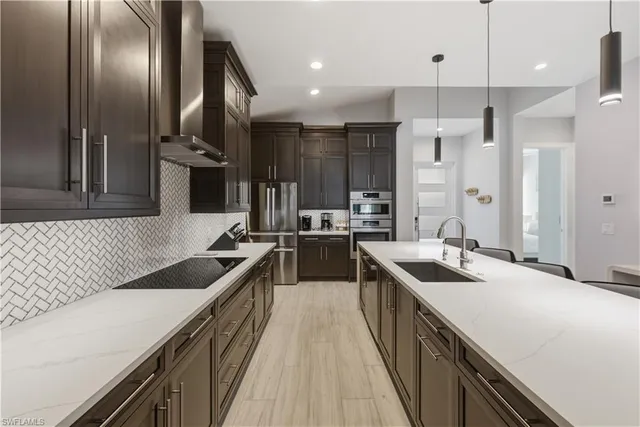 a kitchen with a sink stove and refrigerator