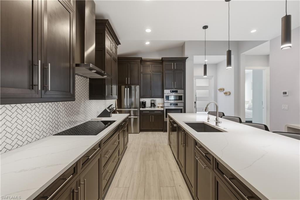 711 91st Avenue North Naples, FL 34108 - Photo 6 of 27 a kitchen with a sink stove and refrigerator