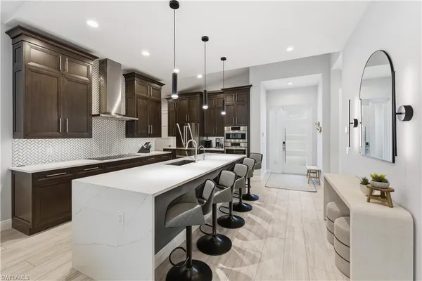 a kitchen with a sink stainless steel appliances and cabinets