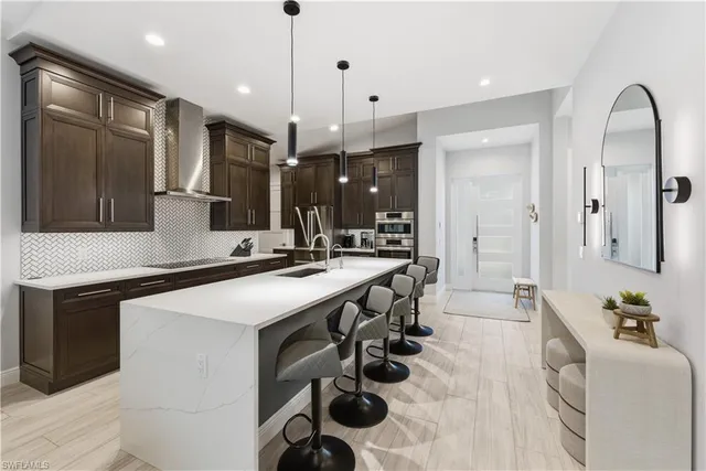 a kitchen with a sink stainless steel appliances and cabinets
