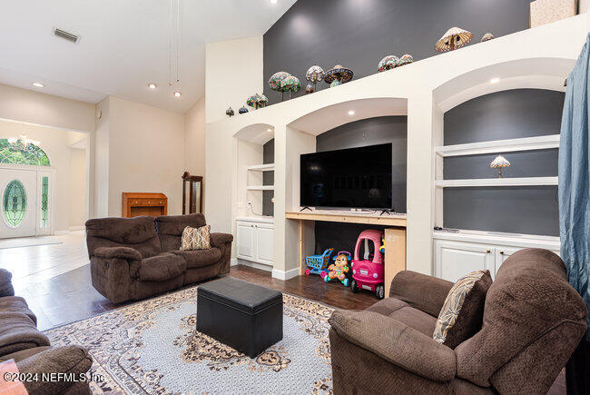 8092 Collins Road Jacksonville, FL 32244 - Photo 13 of 42 a living room with furniture and a flat screen tv
