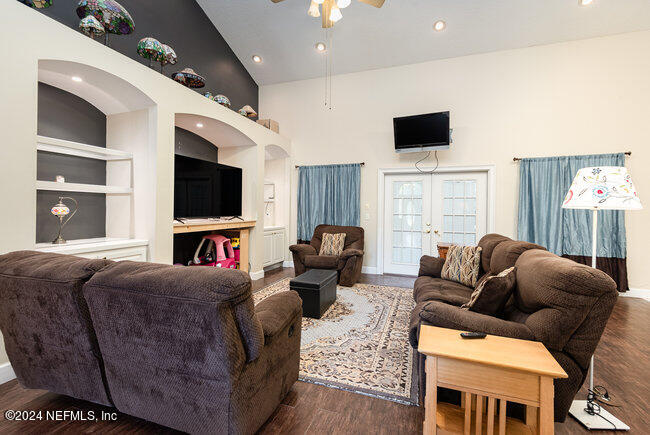 8092 Collins Road Jacksonville, FL 32244 - Photo 14 of 42 a living room with furniture and a flat screen tv