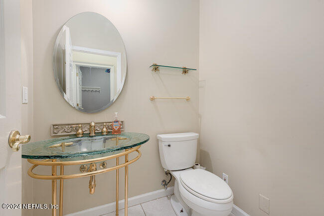 8092 Collins Road Jacksonville, FL 32244 - Photo 16 of 42 a bathroom with a toilet sink and mirror