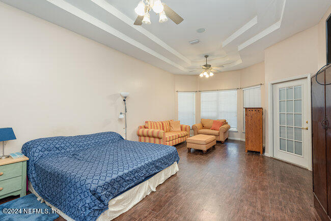 8092 Collins Road Jacksonville, FL 32244 - Photo 17 of 42 a living room with furniture and a chandelier