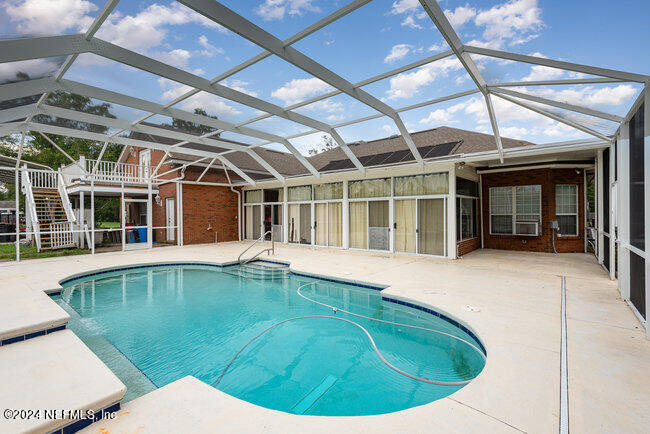 8092 Collins Road Jacksonville, FL 32244 - Photo 31 of 42 a view of a house with pool and porch