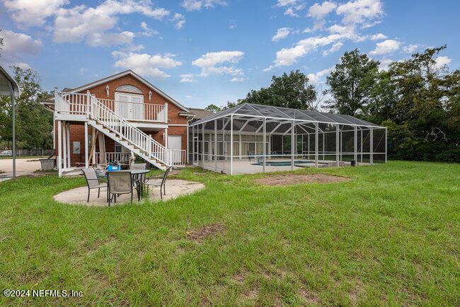8092 Collins Road Jacksonville, FL 32244 - Photo 34 of 42 a view of a house with a yard and sitting area