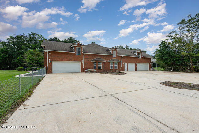 8092 Collins Road Jacksonville, FL 32244 - Photo 38 of 42 a front view of a house with a yard and trees