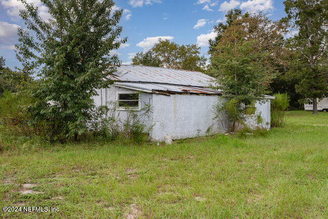 8092 Collins Road Jacksonville, FL 32244 - Photo 40 of 42 a view of a backyard with a garden