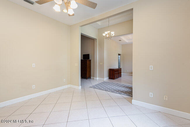 8092 Collins Road Jacksonville, FL 32244 - Photo 5 of 42 a view of a hallway with a chandelier fan and livingroom view