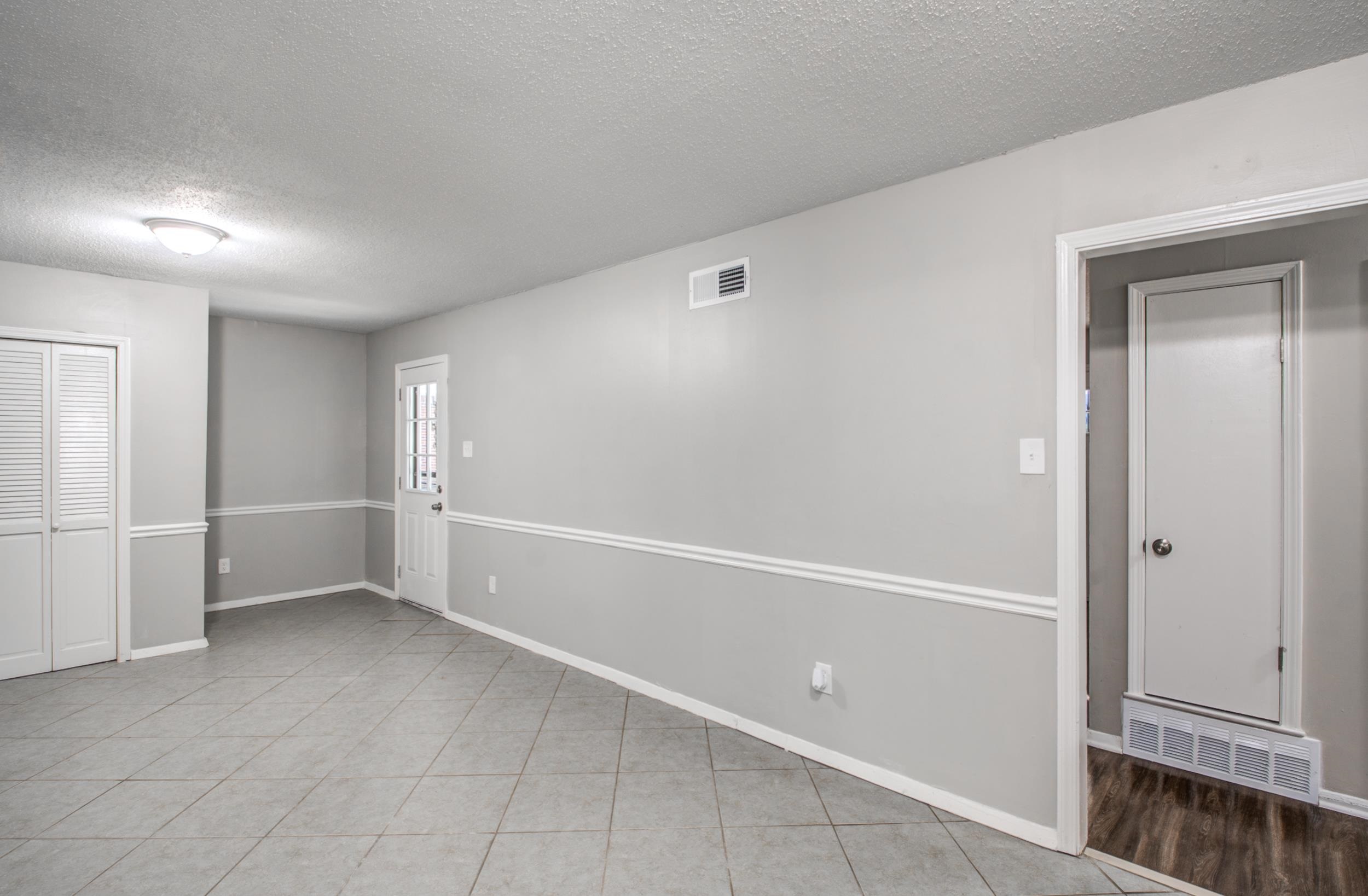 4174 Hobson Road Memphis, TN 38128 - Photo 7 of 24 Empty room with a textured ceiling and light tile patterned floors