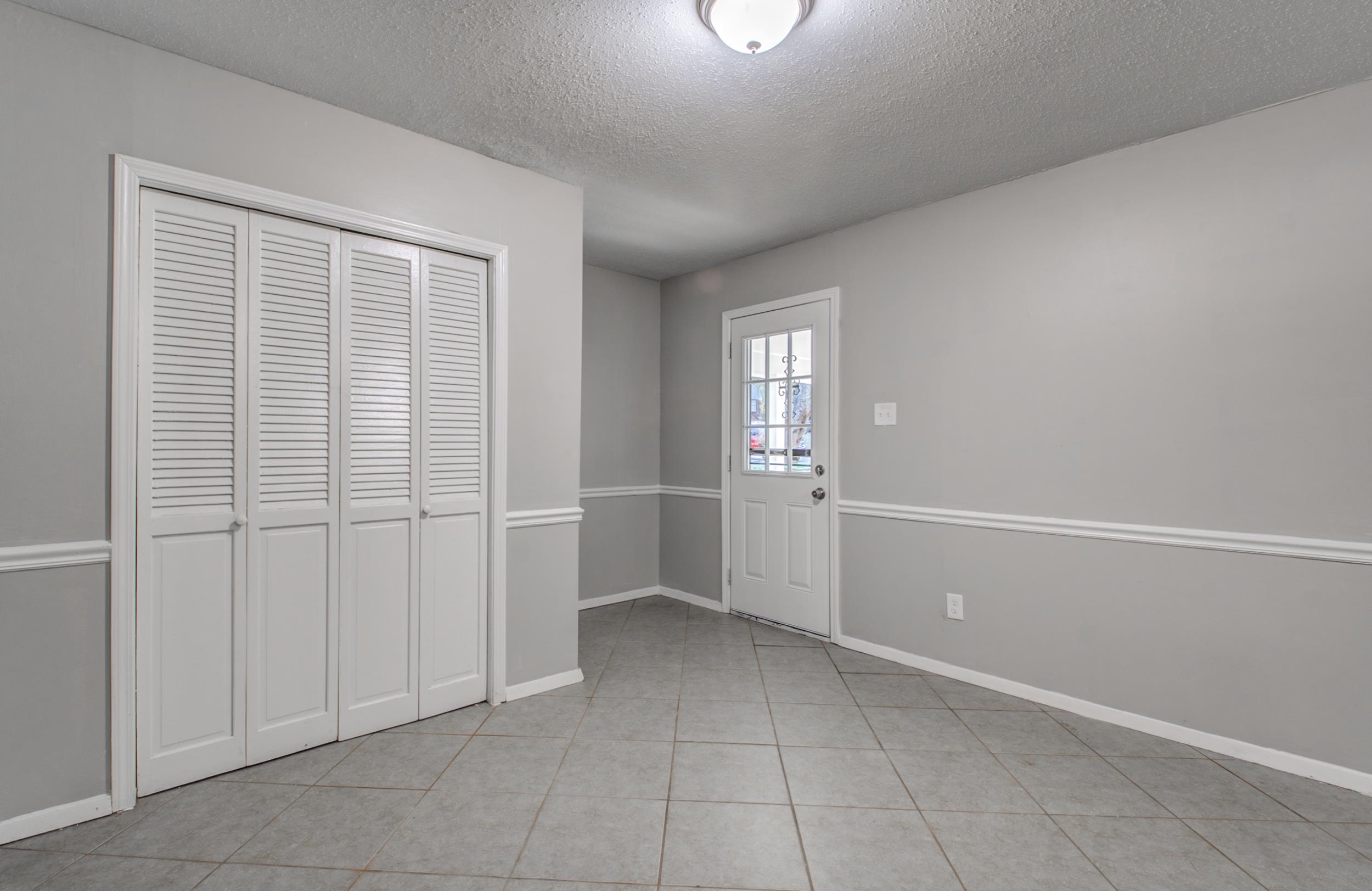 4174 Hobson Road Memphis, TN 38128 - Photo 8 of 24 Unfurnished dining area with a textured ceiling and light tile patterned floors