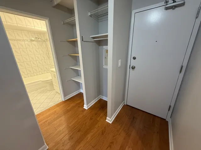 a view of an empty room with wooden floor