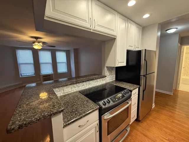 a kitchen with granite countertop cabinets and steel stainless steel appliances